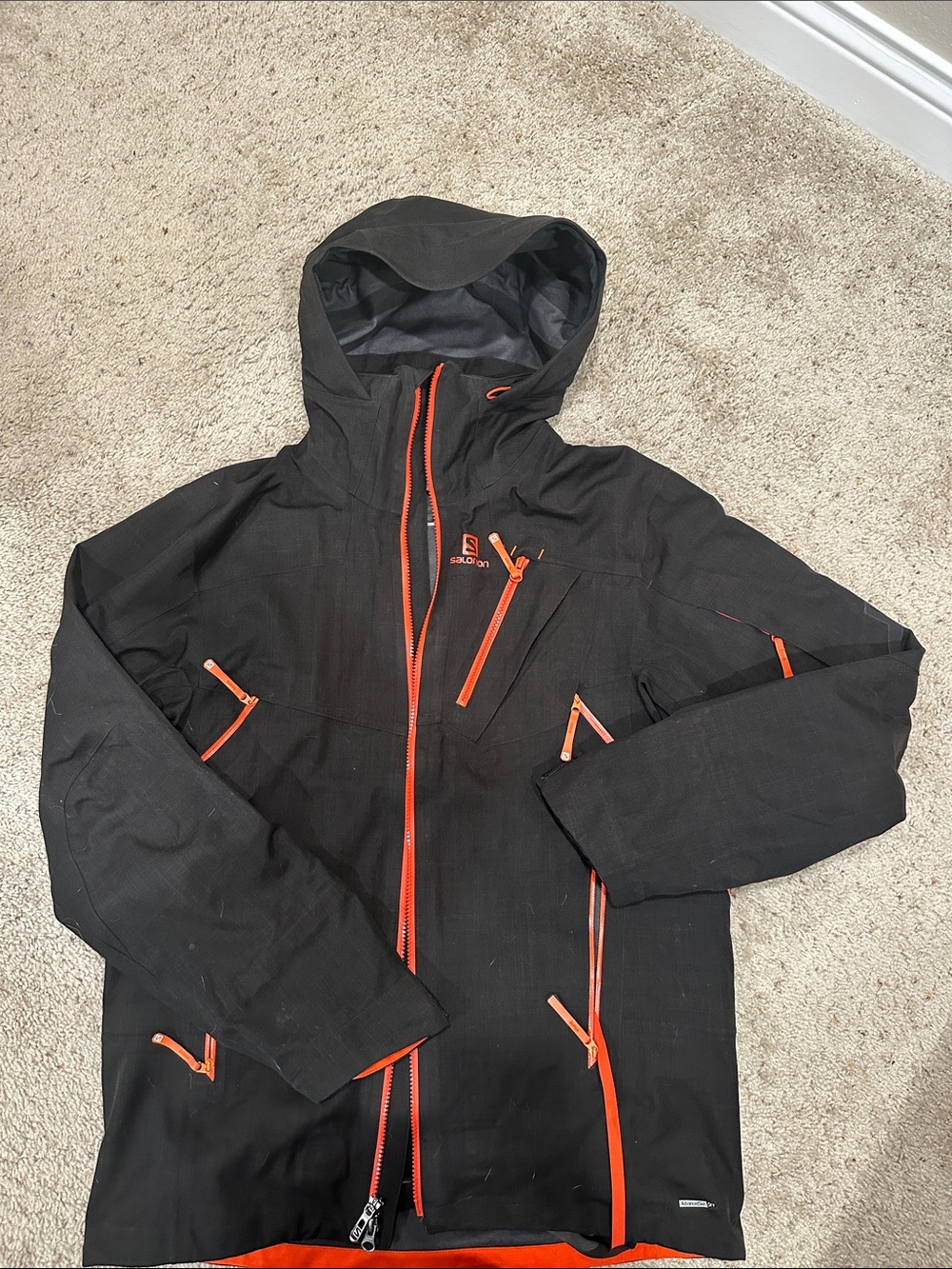 Salomon Forsight. Men’s Black ski Jacket shell with Orange Zippers